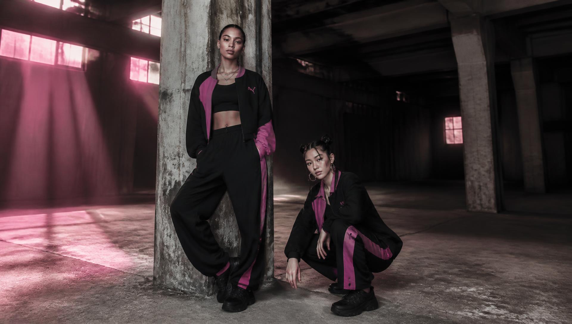 Two models in Dirty Diana streetwear inside an industrial warehouse